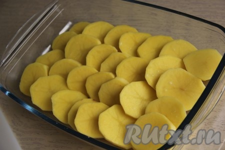 Нарезать картофелины на кружочки толщиной 1 см, затем немного посолить и выложить в форму для запекания внахлёст (как на фото).