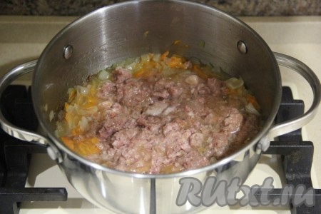 Далее выложить к овощам тушёнку и перемешать, разбивая мясо на кусочки.
