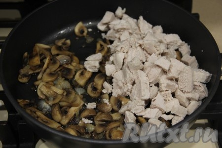Отваренное куриное филе нарезать на кубики и добавить в сковороду к грибам. 