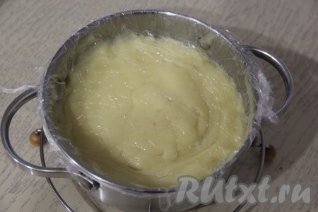 Закрыть крем пищевой плёнкой так, чтобы она касалась поверхности крема (благодаря тому, что плёнка контактирует с кремом, на его поверхности, пока он остывает, не будет образовываться корочка). Крем оставить в таком виде остывать.