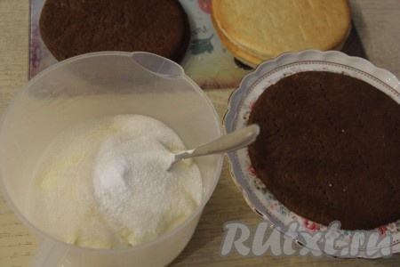 Для приготовления крема соединить сметану и сахар, перемешать ложкой и оставить на 5-7 минут (до полного растворения сахара в сметанном креме).