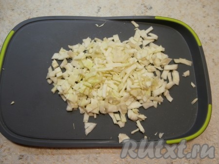 Нашинковать капусту, а затем нарезать её на более мелкие кусочки, чуть посолить и помять руками.