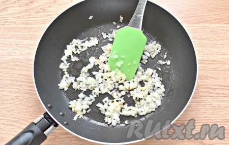 Очищаем половину луковицы и мелко нарезаем. Прогреваем растительное масло на сковороде, выкладываем лук и обжариваем его, помешивая, на среднем огне до лёгкой румяности (в течение 2-3 минут).  