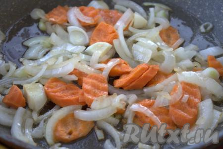 В сковороду влить растительное масло, выложить лук и нарезанную на кружочки морковь.