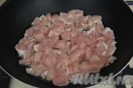 В сковороду влить растительное масло, разогреть. Нарезать куриное филе на небольшие кусочки и выложить в сковороду.