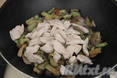 Жарить баклажаны на среднем огне минут 10, перемешивая. Затем в сковороду с баклажанами добавить обжаренные кусочки курицы.