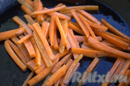 В ту же сковороду, в которой обжаривалась говядина, выложить брусочки моркови. Обжарить морковку на среднем огне до мягкости, не забывая помешивать.