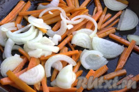 Далее в сковороду к моркови добавить нарезанный лук, хорошо перемещать и обжаривать овощи, периодически помешивая, минуты 2-3.