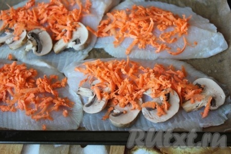 На смазанный противень или на бумагу для запекания положить филе тилапии, на него выложить порезанные шампиньоны и тёртую морковь.