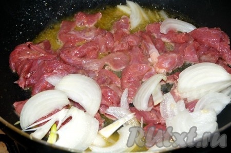На сковороду выложить топленое масло, на нем обжарить мясо с луком.