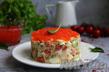 Салат, приготовленный из кальмаров с яйцом, украсить сверху красной икрой и подать яркое, вкусное, нежное блюдо к столу.