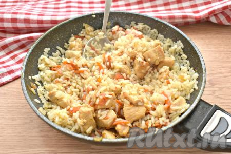 Перемешиваем рис с курицей, сковороду накрываем крышкой и томим ленивый плов на небольшом огне 2-3 минуты.