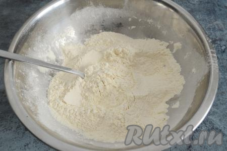 В глубокую миску всыпать 240 грамм муки, сахар, соль и разрыхлитель. При помощи столовой ложки смешать сухие ингредиенты до однородности.