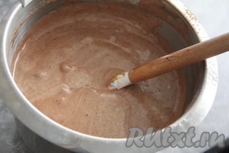 Теперь займёмся выпечкой бисквита, для этого в глубокой ёмкости нужно яйца взбить с сахаром в течение 5 минут с помощью миксера. Яичная масса должна увеличиться в объёме, стать более пышной и светлой. К взбитым яйцам всыпать просеянную муку, какао и разрыхлитель, перемешать тесто лопаткой. Тесто для шоколадного бисквита получится воздушным, не густым.