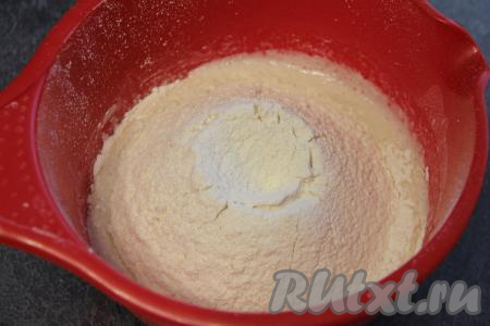 Всыпать соль и частями начать добавлять в тесто муку, перемешивая тесто вначале ложкой.