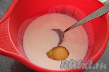 Кефир влить в глубокую миску, добавить соду, хорошо перемешать столовой ложкой и оставить на 4-5 минут. За это время сода погасится в кефире и смесь запенится. В запенившуюся смесь добавить яйцо, перемешать.