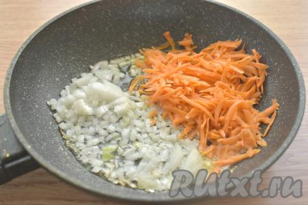 Очищаем морковку и репчатый лук. Лук нарезаем на маленькие кусочки, натираем морковку на крупной тёрке. Разогреваем на сковороде растительное масло, огонь уменьшаем до среднего, выкладываем морковку с луком, перемешиваем и обжариваем овощи 5-6 минут (до мягкости моркови), иногда перемешивая. Затем убираем обжаренные овощи с огня, даём остыть.