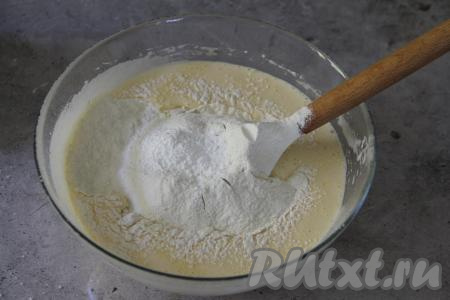 Всыпать разрыхлитель и половину просеянной муки, перемешать тесто для лимонных маффинов лопаткой. Затем начать по столовой ложке добавлять муку в тесто, каждый раз хорошо перемешивая тесто лопаткой.