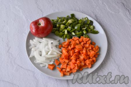 Из болгарского перца удалите семена с плодоножкой. Очистите морковь, чеснок и луковицу. Перец нарежьте на небольшие кусочки, морковь - на мелкие кубики, лук - на полукольца (или четверть кольца).