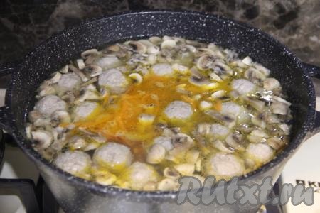 После того как картошка вместе с фрикадельками проварится 10 минут, добавить в суп нарезанные шампиньоны и обжаренные овощи, дать закипеть и варить на небольшом огне 10 минут.