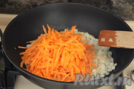 К обжаренному луку добавить натёртую на крупной тёрке морковку, перемешать и обжаривать овощи вместе минут 5, периодически помешивая.