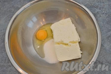 А пока начнём замешивать тесто для сырников, для этого в объёмной миске нужно соединить сырое яйцо, сахар и творог.