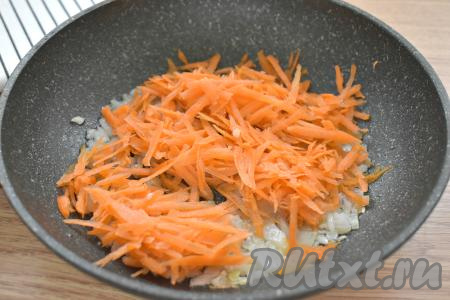 Когда лук станет мягким, добавляем к нему очищенную морковку, натёртую на крупной тёрке, перемешиваем и обжариваем овощи, иногда помешивая, 4-5 минут (до мягкости моркови).