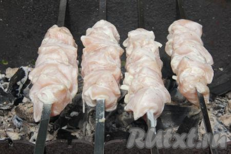 Поместить шампуры с мясом курицы на мангал с подготовленными углями. Жарить шашлык без прямого огня, используя только жар углей.