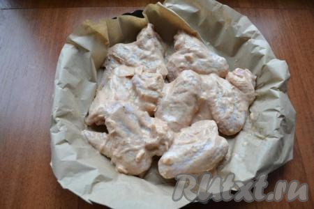 В любую подходящую форму для запекания, предварительно застеленную пергаментом, выложить крылышки в один слой.