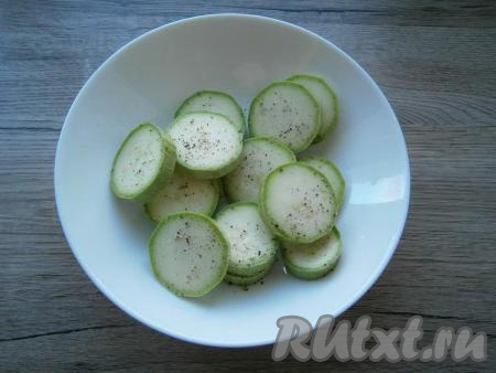 Кабачок (молодой кабачок можно не очищать от кожуры) нарезать кружочками толщиной около 1 см, посолить и поперчить.