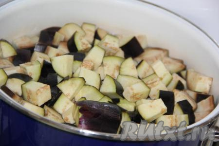 В большой кастрюле вскипятить воду, посолить по вкусу. Опустить кусочки баклажанов в кипящую воду, довести до кипения и, уменьшив огонь, варить 10 минут, помешивая и утапливая баклажаны в воду.