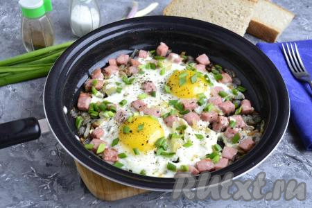 Сразу же очень вкусную яичницу, приготовленную с луком и колбасой, подать к столу.