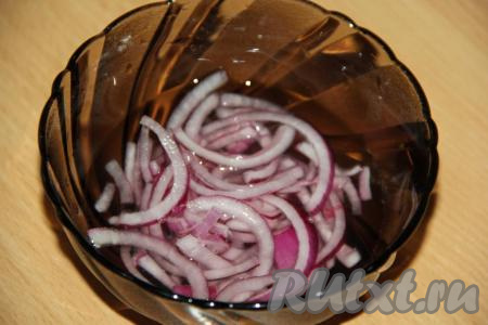 Готовые гренки остудить. Лук очистить и нарезать тонкими полукольцами (или кольцами). Для приготовления маринада смешать 2 столовые ложки воды, 2 столовые ложки уксуса 9% и половину чайной ложки сахара. В получившийся маринад выложить нарезанный лук и дать ему промариноваться в течение минут 30, а затем откинуть на дуршлаг.