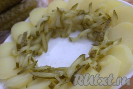 Рядом с картофелем по кругу, ближе к центру, выложить нарезанные солёные огурцы (как на фото).