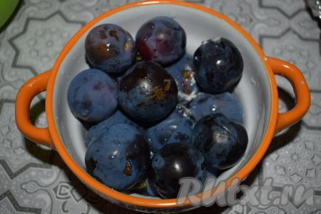 Удаляем из слив косточки, разрезая их на половинки.