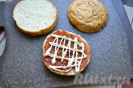 Нижнюю часть булочки смазать томатным соусом и майонезом.

