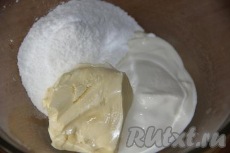 Сливочное масло заранее достать из холодильника, чтобы оно прогрелось при комнатной температуре и стало достаточно мягким. Для того чтобы замесить тесто, соединить в миске мягкое масло, сахарную пудру и сметану, перемешать массу ложкой.