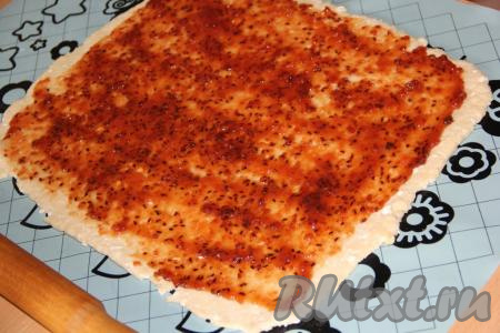 Раскатанный пласт, немного отступив от краёв, смазать вареньем.