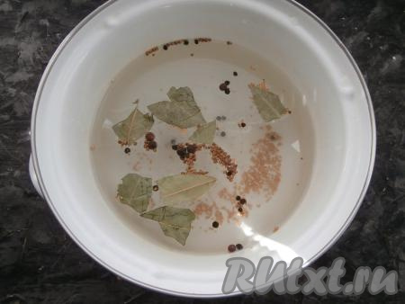 Приготовить маринад для огурцов, для этого 1,5 литра воды в кастрюле довести до кипения, добавить соль, сахар, зёрна кориандра и горчицы, перец чёрный и душистый горошком. Также положить лавровый лист, после закипания проварить маринад минут 5, влить столовый уксус.