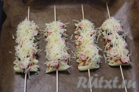 Присыпать шпажки с макаронами оставшимся натёртым сыром. 