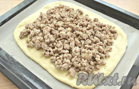 Равномерно выкладываем на тесто остывшую мясную начинку, оставляя по 2 сантиметра от краёв теста.