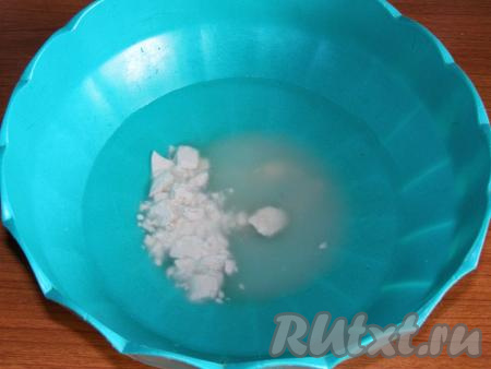 Изюм промываем тёплой водой, выкладываем на салфетки (или на полотенце) и даём обсохнуть. В глубокую миску наливаем тёплую воду (температура воды примерно 35-40 градусов), добавляем сахар, ванильный сахар и размешиваем, чтобы сахар растворился. Добавляем в сладкую воду дрожжи и ещё раз хорошо перемешиваем.