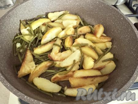 Жарить картошку с чесночными стрелками минут 10 (до готовности картошки и чесночных стрелок). Картофель должен стать мягким внутри и покрытым аппетитной корочкой снаружи. Стрелки должны стать мягкими. Время жарки картошки зависит от сорта картофеля.