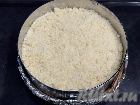 Присыпать верх ватрушки оставшейся крошкой, полностью покрывая сливы. 