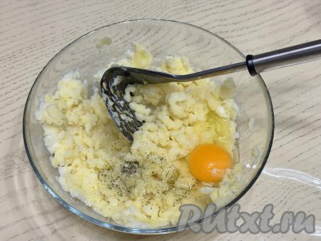 Очистить картофель, нарезать на части, выложить в кастрюлю, залить полностью водой и поставить на сильный огонь. После закипания воды, добавив соль, отварить картошку до готовности (ориентировочно в течение минут 20-25, готовые картошины будут легко прокалываться ножом). Убрать кастрюлю со сварившимся картофелем с огня. Слить воду из кастрюли, в которой варилась картошка. Дать картофелю немного остыть. Тёплую картошку размять толкушкой до однородности, добавить яйцо, молоко, чёрный молотый перец.
