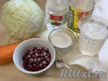 Подготовить продукты для приготовления капусты "Провансаль" с клюквой. Морковь и чеснок почистить. Свежую клюкву промыть водой (я использовала замороженные ягоды). Капусту промыть водой, верхние листья убрать.