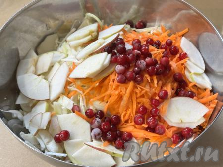 В миску с капустой выложить яблоко, морковь и клюкву.