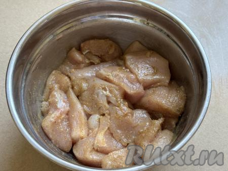 Хорошо перемешать кусочки мяса, покрывая их маслом и специями со всех сторон. Миску с кусочками куриной грудки накрыть крышкой и оставить мариноваться при комнатной температуре на 30 минут.