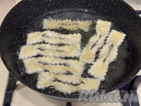 В сковороду (или сотейник) влить достаточное количество растительного масла, хорошо его разогреть. Выложить заготовки хвороста в сковороду в один слой. Масла для жарки хвороста не жалейте, потом излишки масла можно будет удалить.