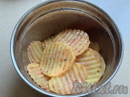 Тщательно перемешать картошку, равномерно покрывая её со всех сторон маслом, солью и специями.